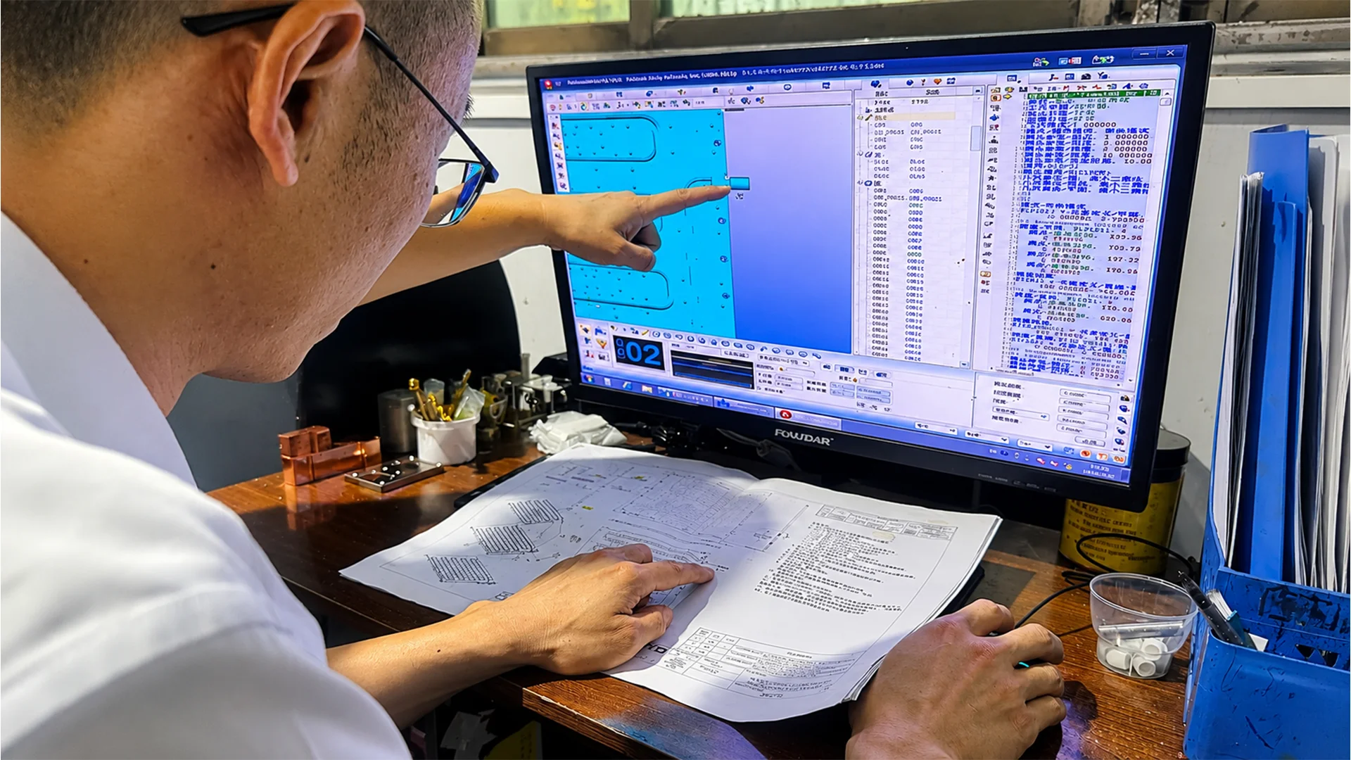 Placeholder for an engineer reviewing a CNC drawing beside a precision metal part and measuring tools